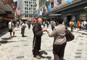 feast-of-st-anthony_27615419156_o A Franciscan Friar distributes St. Anthony's Blessed Bread to a community member on the Feast of St. Anthony